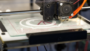 a close up of a 3D printer creating a heated bed